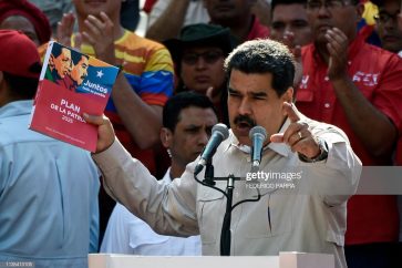 Venezuela's President Nicolas Maduro holds the government's plan for 2025, during a rally at the Miraflores Palace in Caracas, Venezuela on April 6, 2019. - Venezuela's opposition leader Juan Guaido urged his supporters to demonstrate to maintain pressure on Maduro, amid rising anger over the collapse of public services. Pro-Guaido protests drew thousands in rallies across the country, while a pro-Maduro counter-demonstration in Caracas drew thousands of people who marched toward the Miraflores presidential palace. (Photo by Federico Parra / AFP)        (Photo credit should read FEDERICO PARRA/AFP/Getty Images)