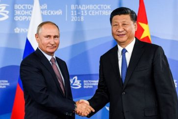 Russian President Putin shakes hands with Chinese President Xi Jinping during a meeting with participants of a round table discussion on Russia-China Cooperation on the sidelines of the Eastern Economic Forum in Vladivostok