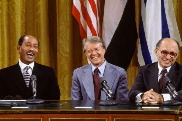 WASHINGTON, DC -- SEPTEMBER 18: (L to R) Egyptian President Anwar al-Sadat, US President Jimmy Carter, and Israeli Premier Menachem Begin laugh together during the signing the Camp David Accords in the East Room of the White House, September 18, 1978, in Washington, DC. The agreement came after twelve days of secret negotiations at Camp David. (Photo by David Hume Kennerly/Getty Images)