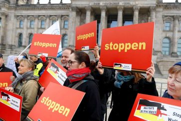 FILE PHOTO: Activists demand the government end worldwide weapons exports during a demonstration in front of Germany's lower house of parliament in Berlin, Germany, February 26, 2019. The words on the banner read "Stop."   REUTERS/Fabrizio Bensch/File Photo