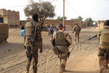Des militaires maliens et français patrouillent dans une rue de Ménaka au Mali le 21 mars