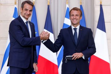 Greek Prime Minister Kyriakos Mitsotakis shakes hands with French President Emmanuel Macron following a signing ceremony of a new defence deal at The Elysee Palace in Paris, France September 28, 2021. Ludovic Marin/Pool via REUTERS