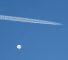 A jet flies by a suspected Chinese spy balloon as it floats off the coast in Surfside Beach, South Carolina, U.S. February 4, 2023.  REUTERS/Randall Hill