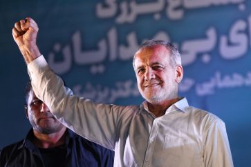 (FILES) Iranian reformist candidate Masoud Pezeshkian raises his fist as he arrives for his campaign rally, two days before a presidential election runoff following a first round marked by a historically low turnout, at a stadium in Tehran on July 3, 2024. Masoud Pezeshkian, Iran's only reformist candidate in the latest presidential election, has risen from relative obscurity to become the ninth president of the Islamic republic on July 6, 2024.  Pezeshkian, 69, won around 53.6 percent of the vote in a runoff election against the ultraconservative Saeed Jalili. (Photo by ATTA KENARE / AFP)