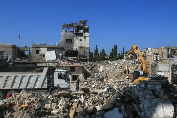 An excavator removes building rubble at the site an Israeli airstrike a day earlier that targeted the Haret Saida neighbourhood in Lebanon's southern city of Sidon on October 30, 2024, killing six people according to the Lebanese health ministry. Israel expanded operations in Lebanon nearly a year after Hezbollah began exchanging fire in support of its ally, the Palestinian Hamas movement after its attack on Israel in October 2023. (Photo by Mahmoud ZAYYAT / AFP)